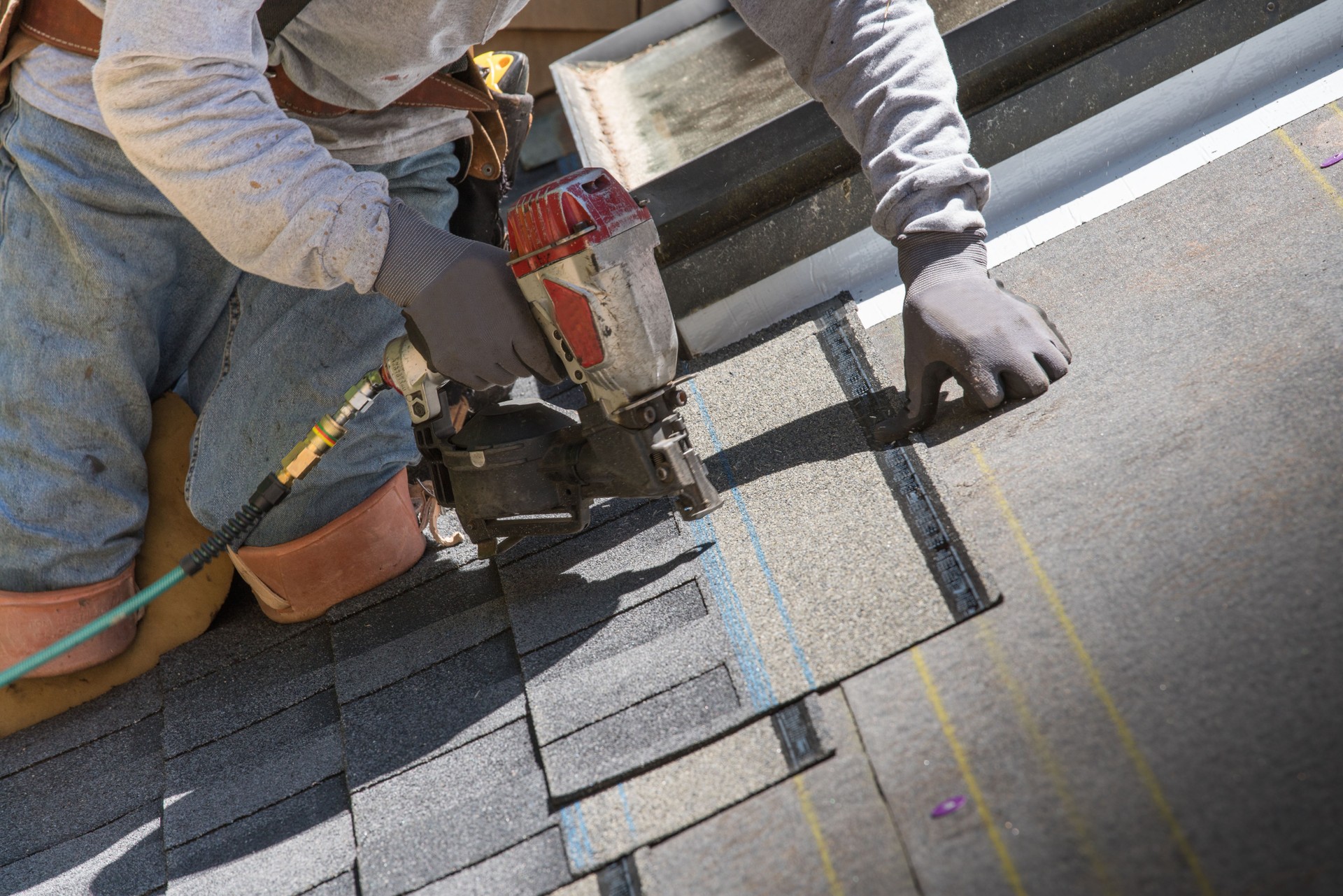 Man installing asphalt roof